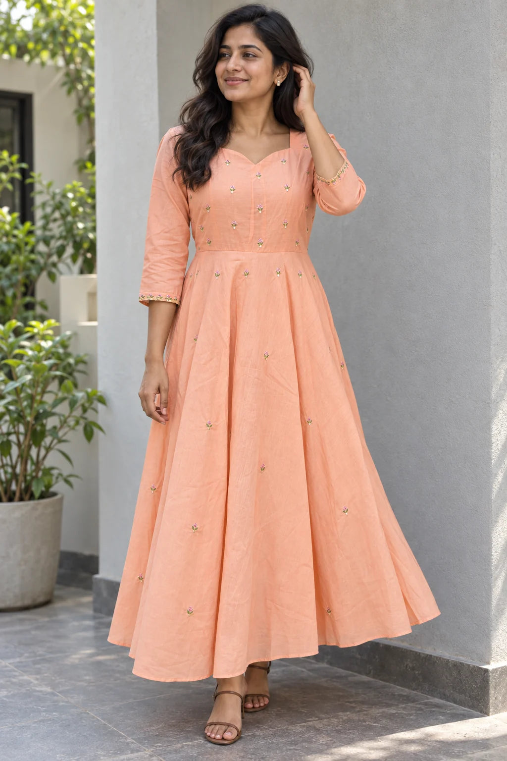 Digital styling view of the peach floral frock on an adult Indian model