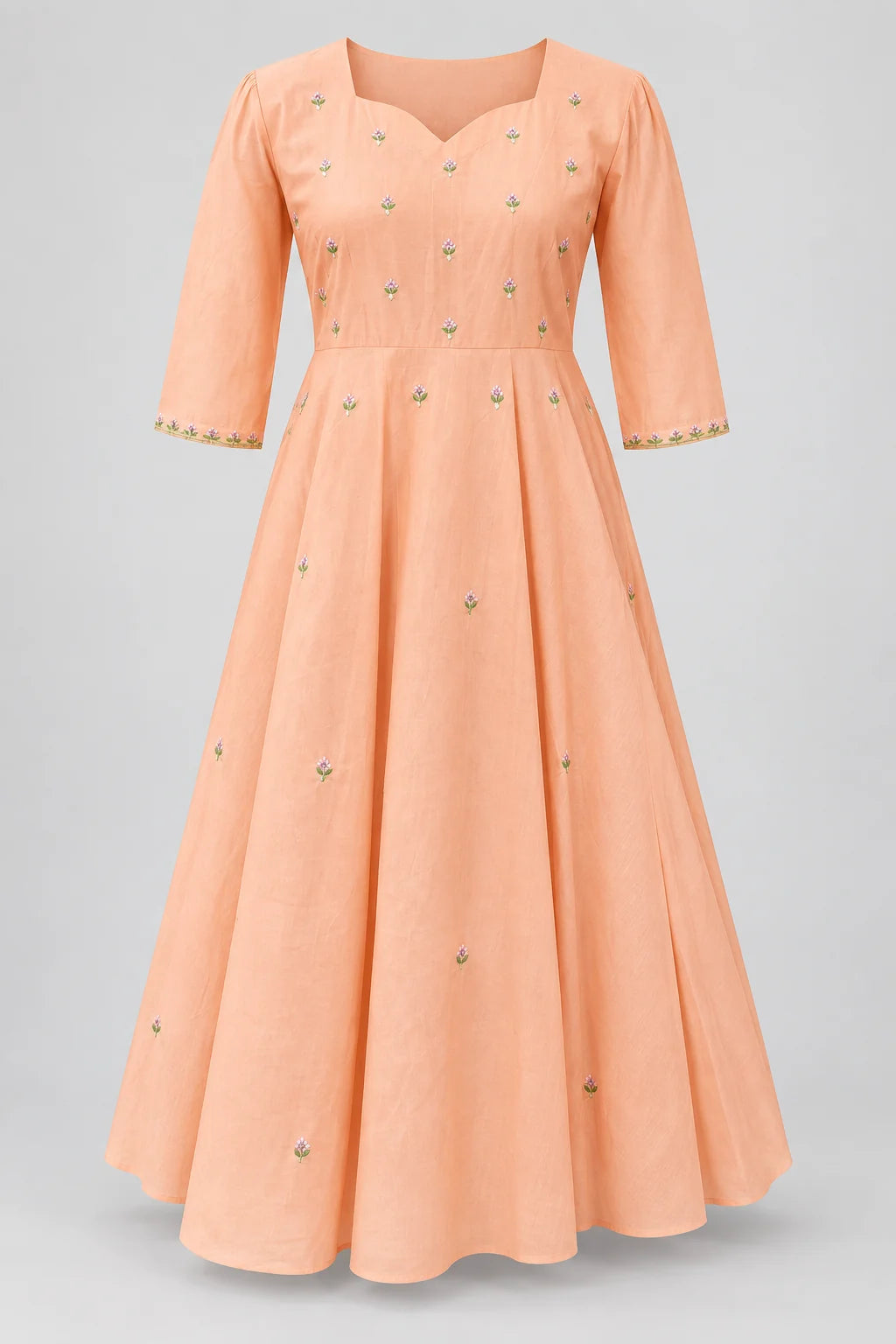 Digitally styled front view of the peach frock showing tiny floral sprigs and three-quarter sleeves