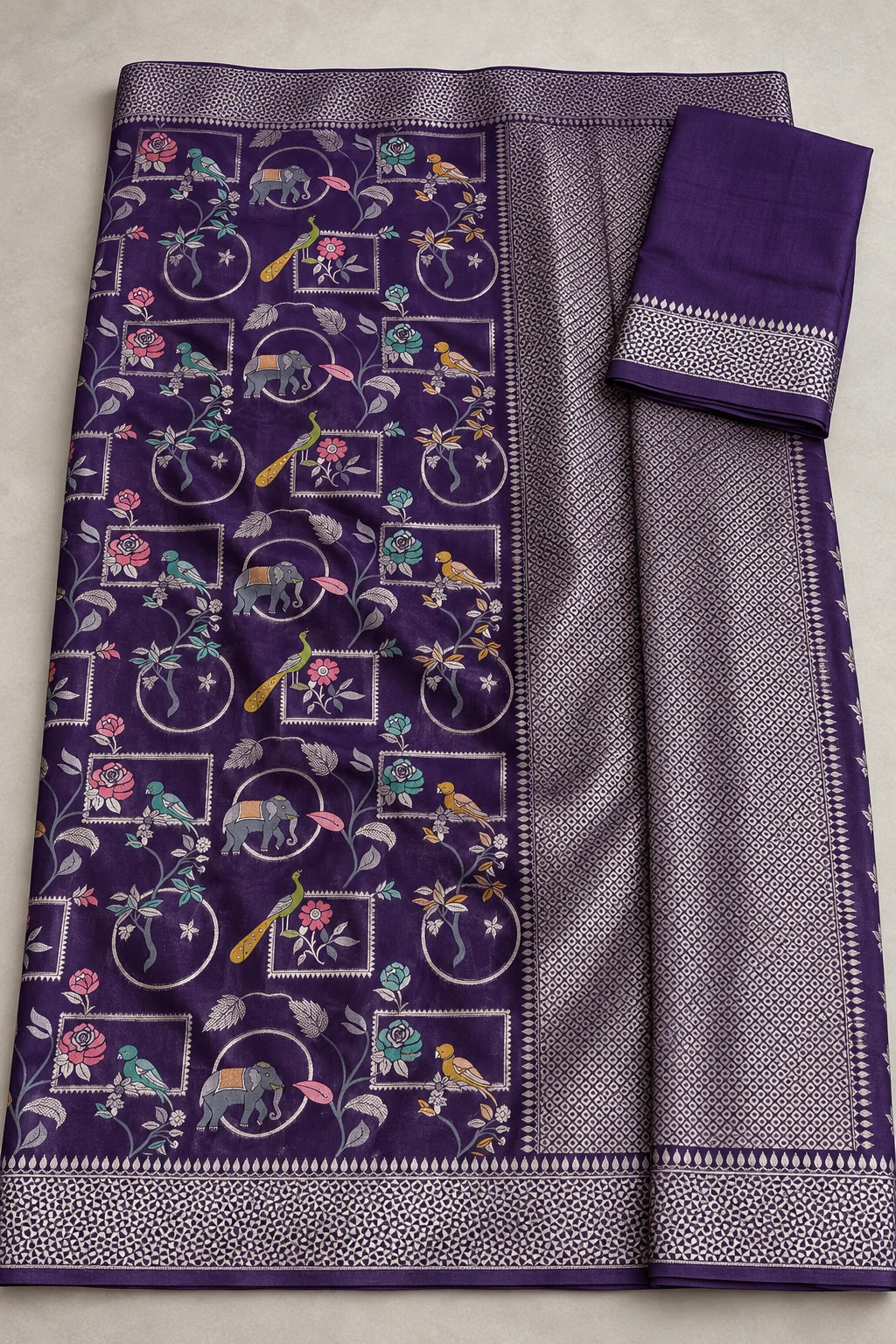 Digitally styled flat lay showing the plum saree motifs, silver-toned pallu and matching fabric