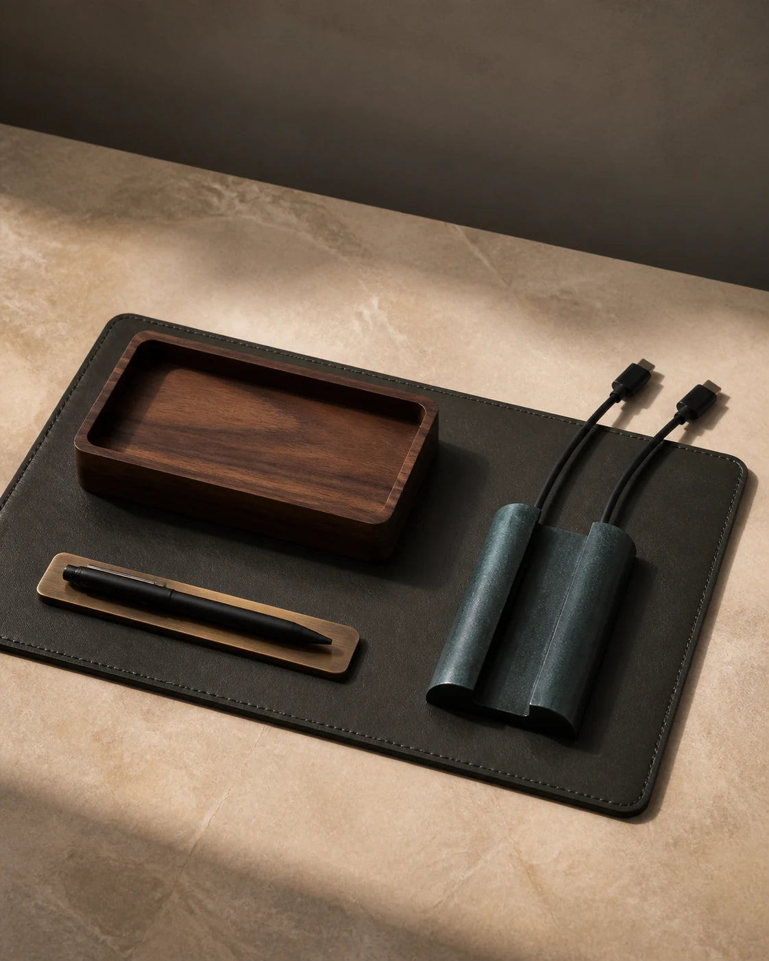 Modular charcoal desk mat with walnut tray, cable bar and brass pen rest