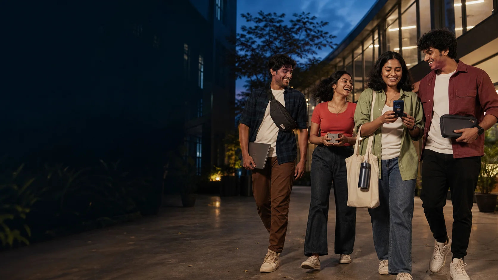 Four Indian young adults leaving a Hyderabad campus courtyard with useful everyday carry