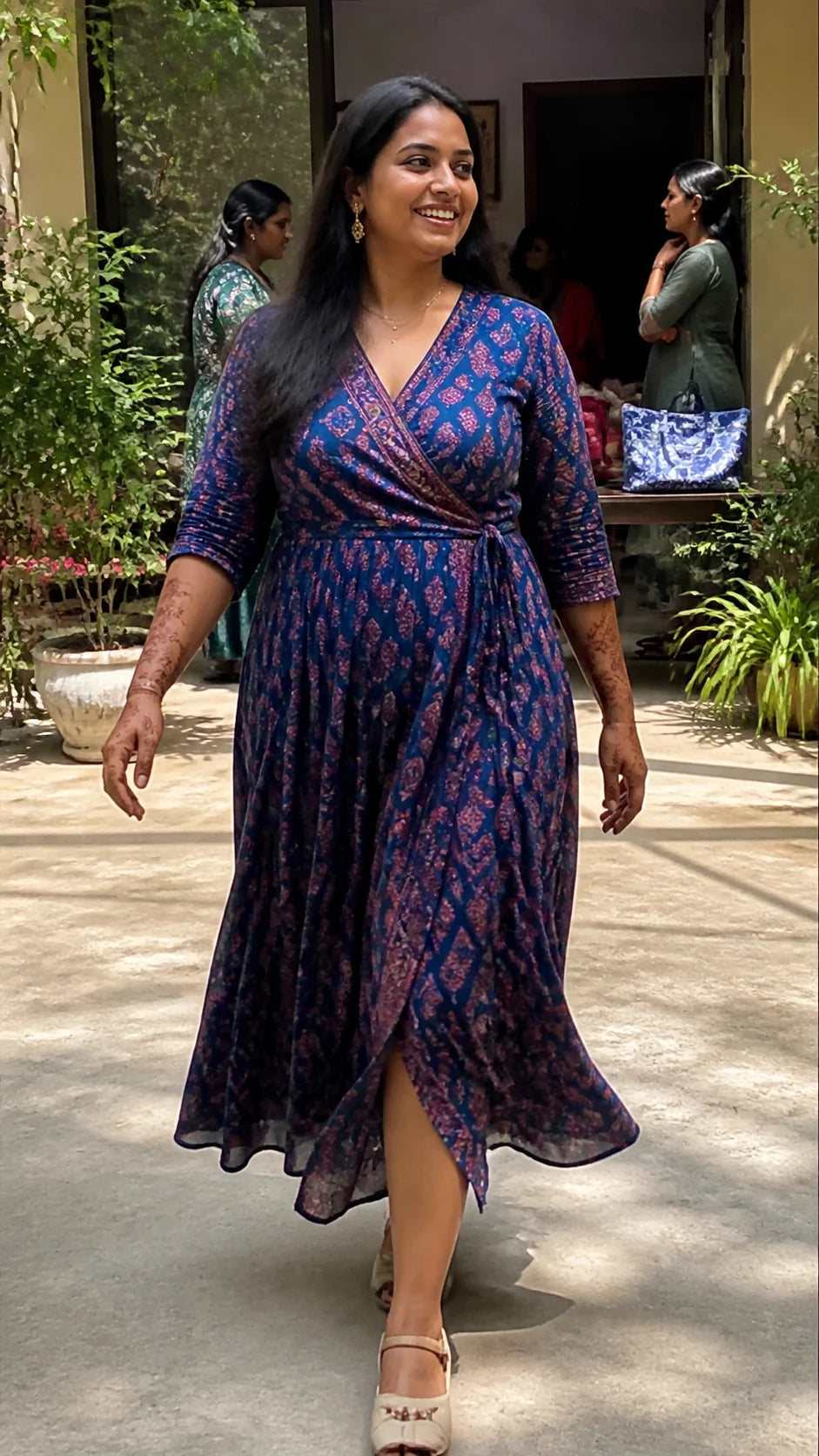 Generated editorial movement study of an Indian wedding guest walking through a courtyard in an indigo wrap dress